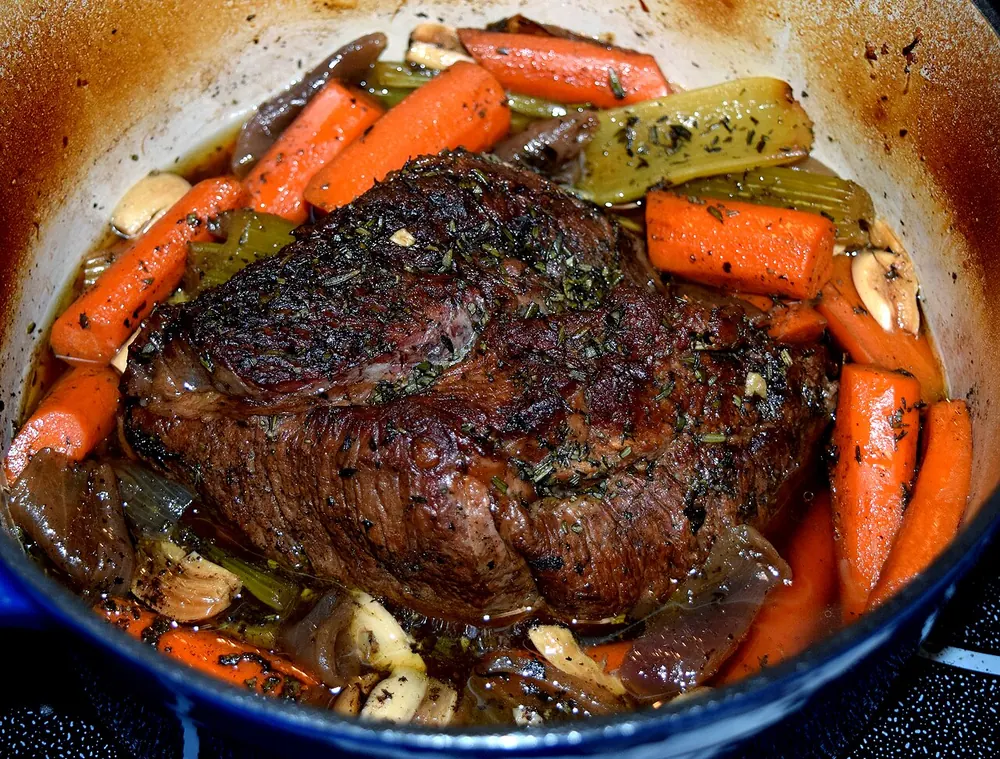 Chuck pot roast with vegetables in a Dutch oven